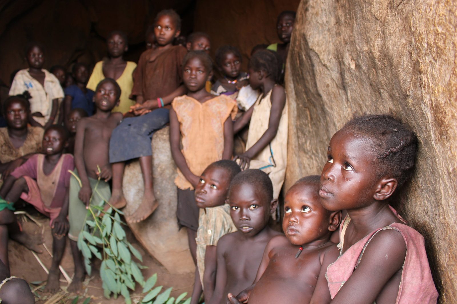 Children sheltering inside a cave in the Nuba Mountains